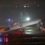 Air Canada Express CRJ-900 aircraft damaged on the runway at LaGuardia Airport after colliding with a fire truck.