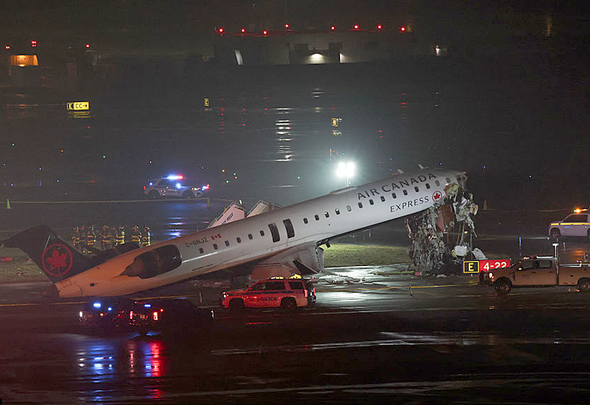 Air Canada Express CRJ-900 aircraft damaged on the runway at LaGuardia Airport after colliding with a fire truck.