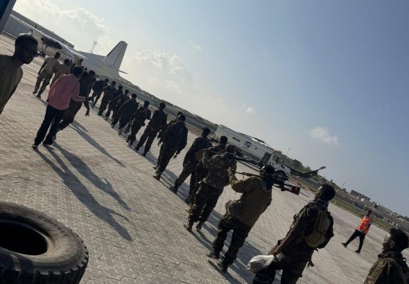 Haramcad police units boarding a Fokker 50 aircraft at Aden Adde Airport for deployment to Barawe