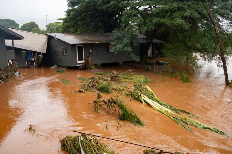 Floodwaters covering streets and homes in Oahu, Hawaii during severe flash flooding and evacuation efforts.